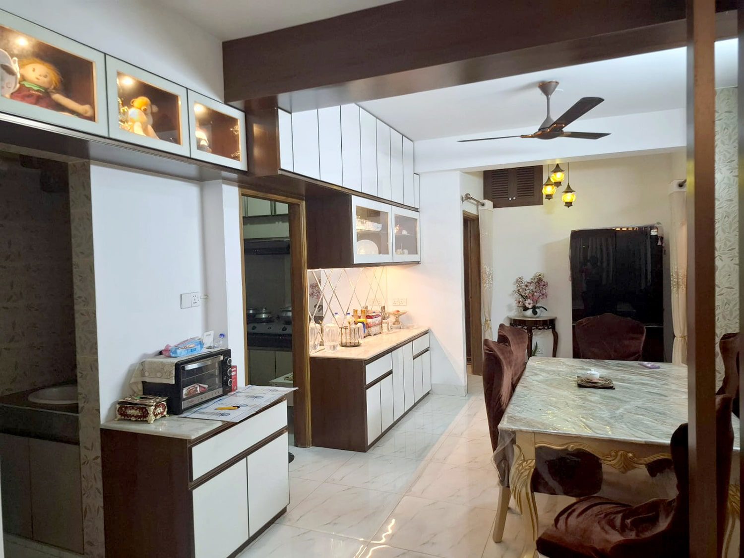 Dining area with built-in display cabinets and ceiling beam - residence interior design for Mr. Khan, Bashundhara, Dhaka