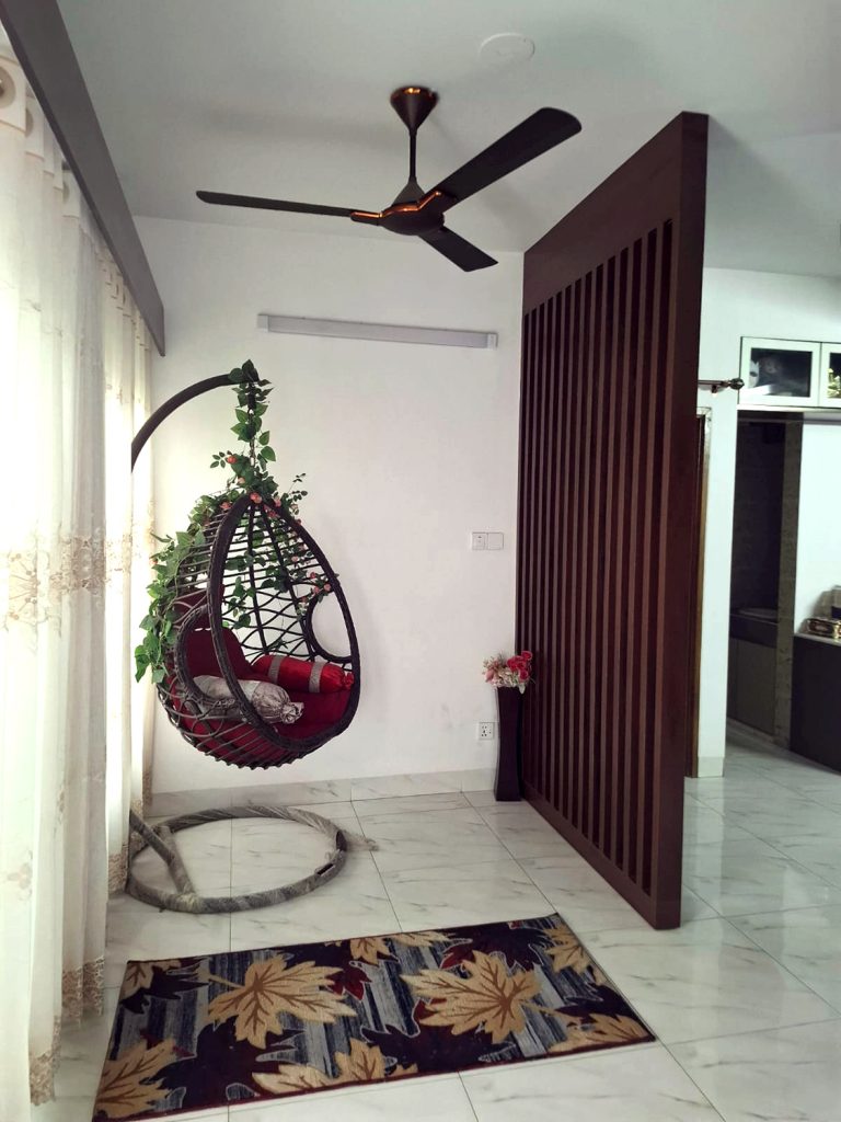 Family living by terrace with indoor swing chair, sliding doors and louver partition