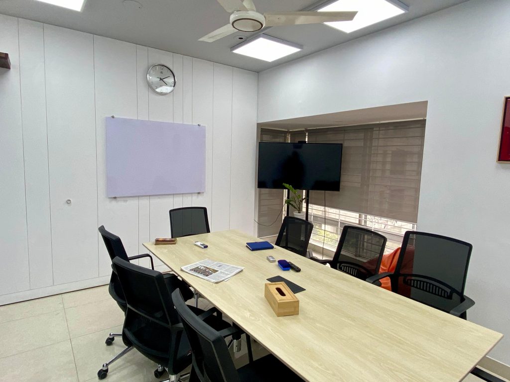 Conference room table with LED task lighting, whiteboard and display at Ek-Pay office