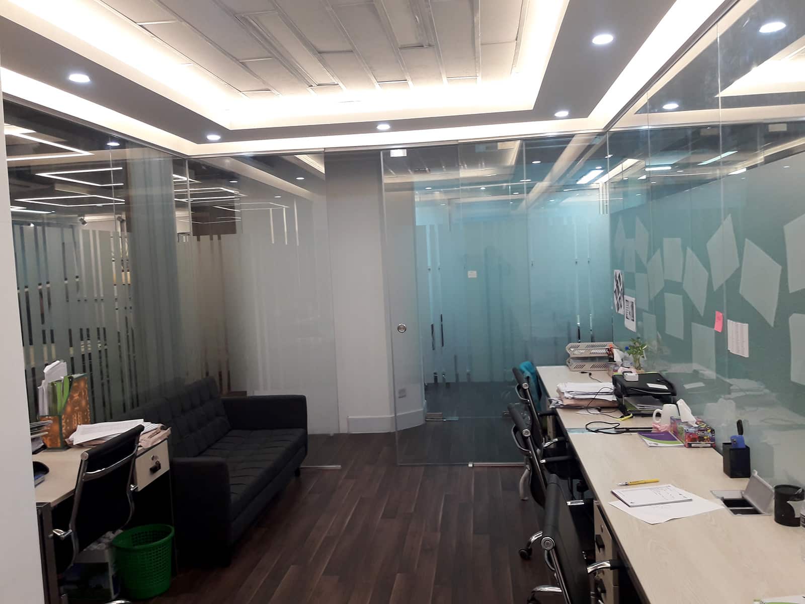 Office corridor with frosted glass partitions, workstation desks and recessed ceiling lighting in office interior, BDBL Tower, Karwan Bazar, Dhaka