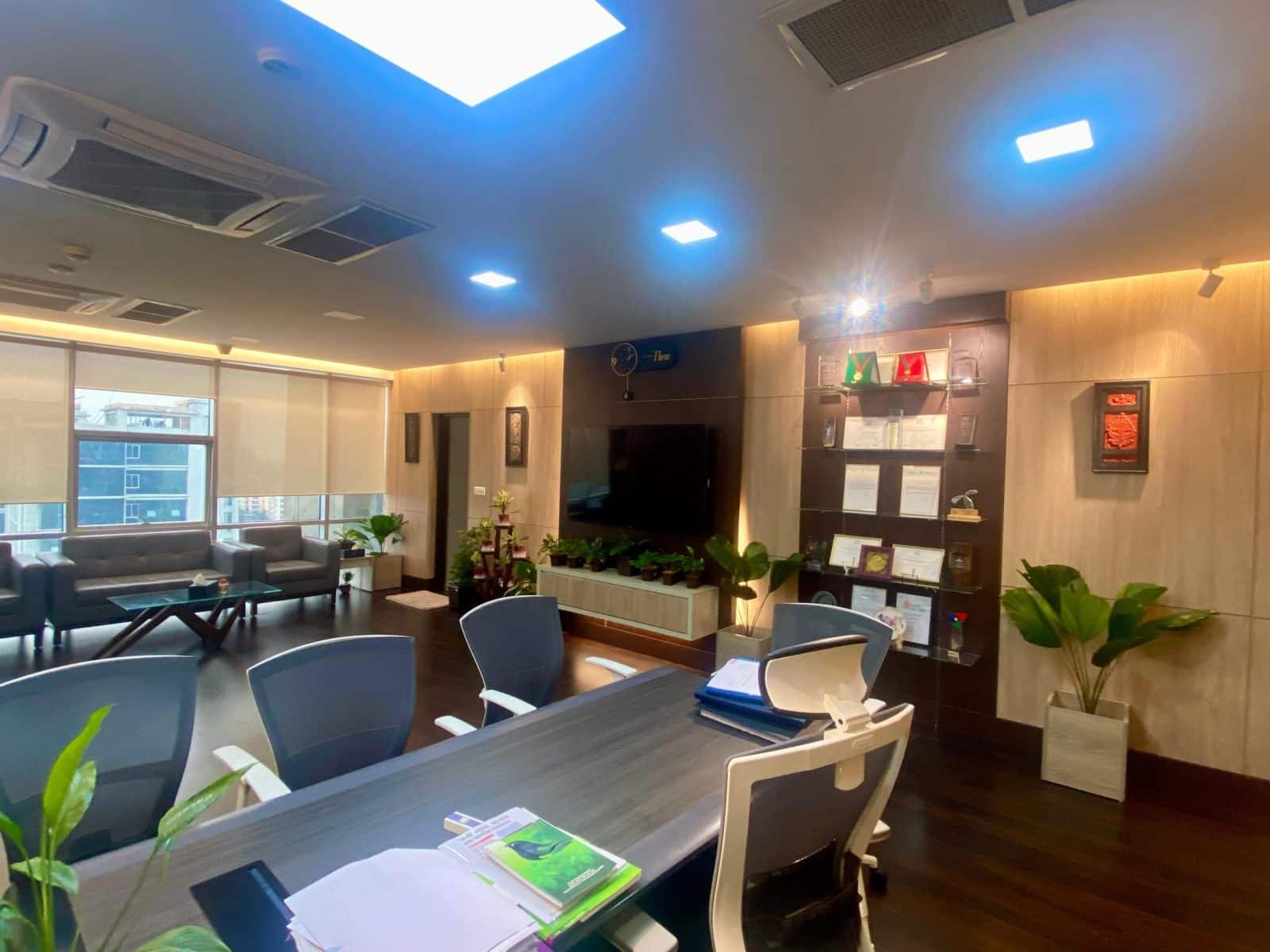 View from CEO chair toward wall panel and glass display shelf with meeting setup, Dhaka - executive office interior design, ICT Tower, Dhaka