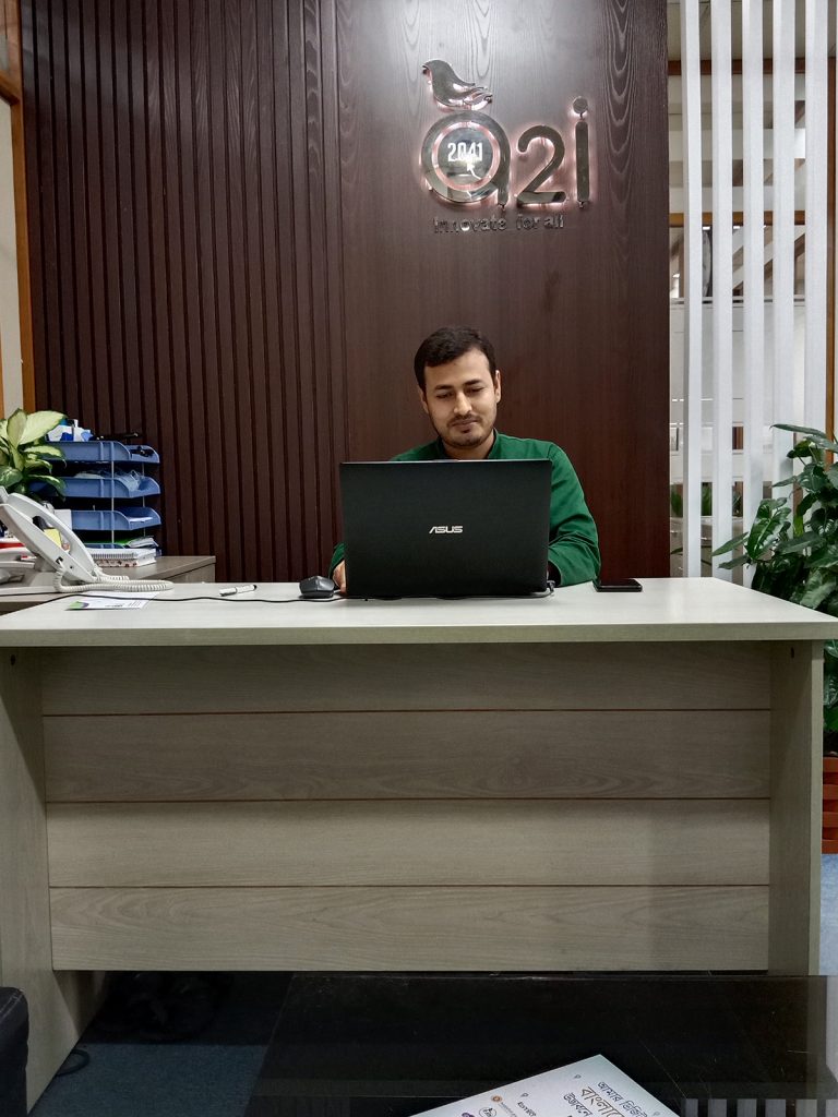 Reception area with custom reception desk, backdrop panel and integrated workspace at IDB Bhaban office renovation