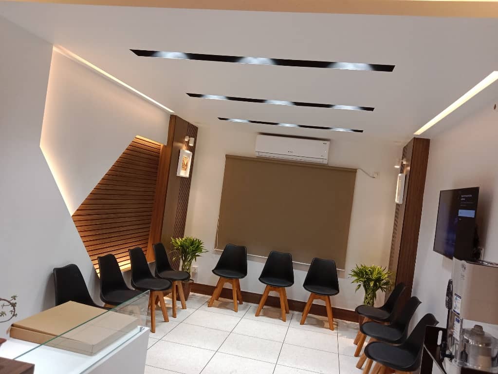 Reception desk with custom furniture and clean finishes Wall panel in Gulshan doctor’s chamber