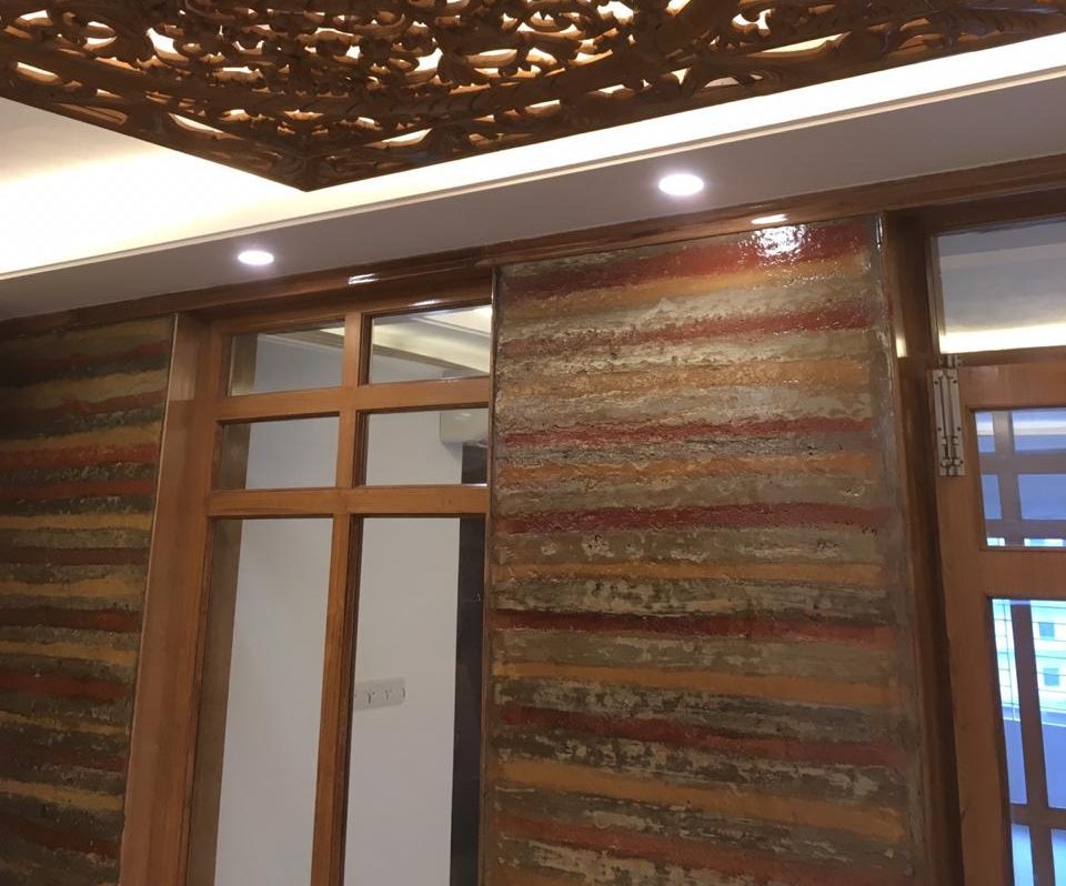 Close-up of mud wall texture with carved wooden ceiling and door frame in small office interior, Pritam Zaman Tower, Dhaka