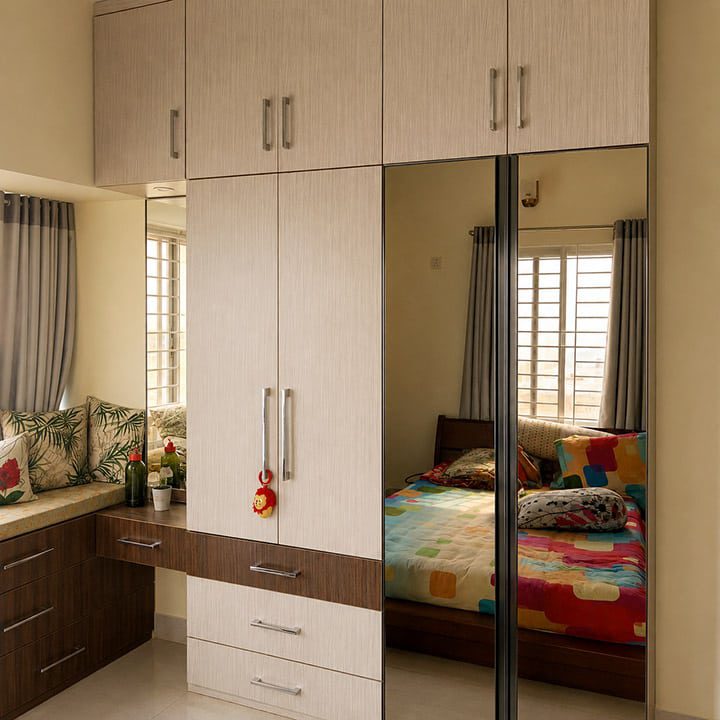 Bedroom with mirrored wardrobe, wall cabinets and cushioned window seat - residence interior design in Rampura, Dhaka