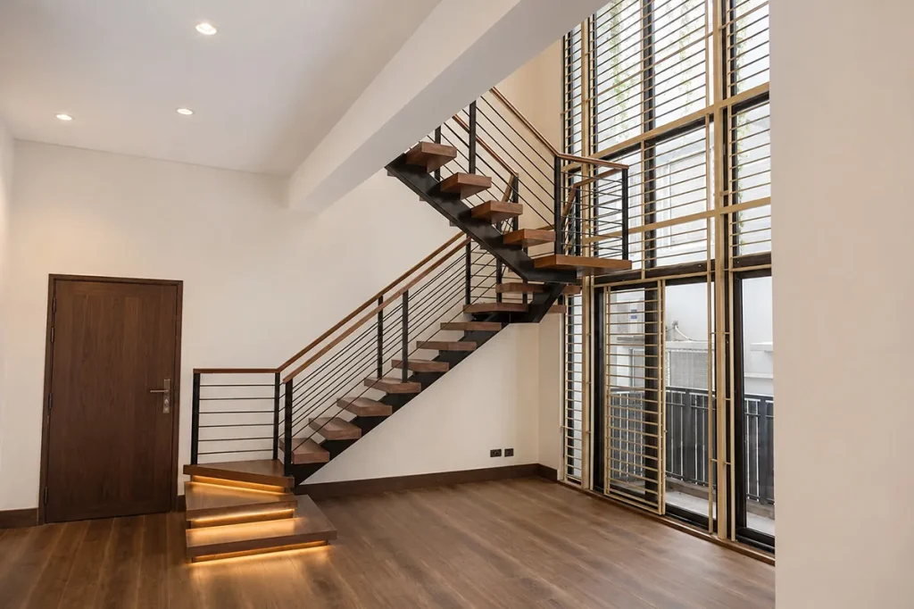Floating timber stair treads and steel railing at the entry - duplex residence interior design, Bashundhara, Dhaka