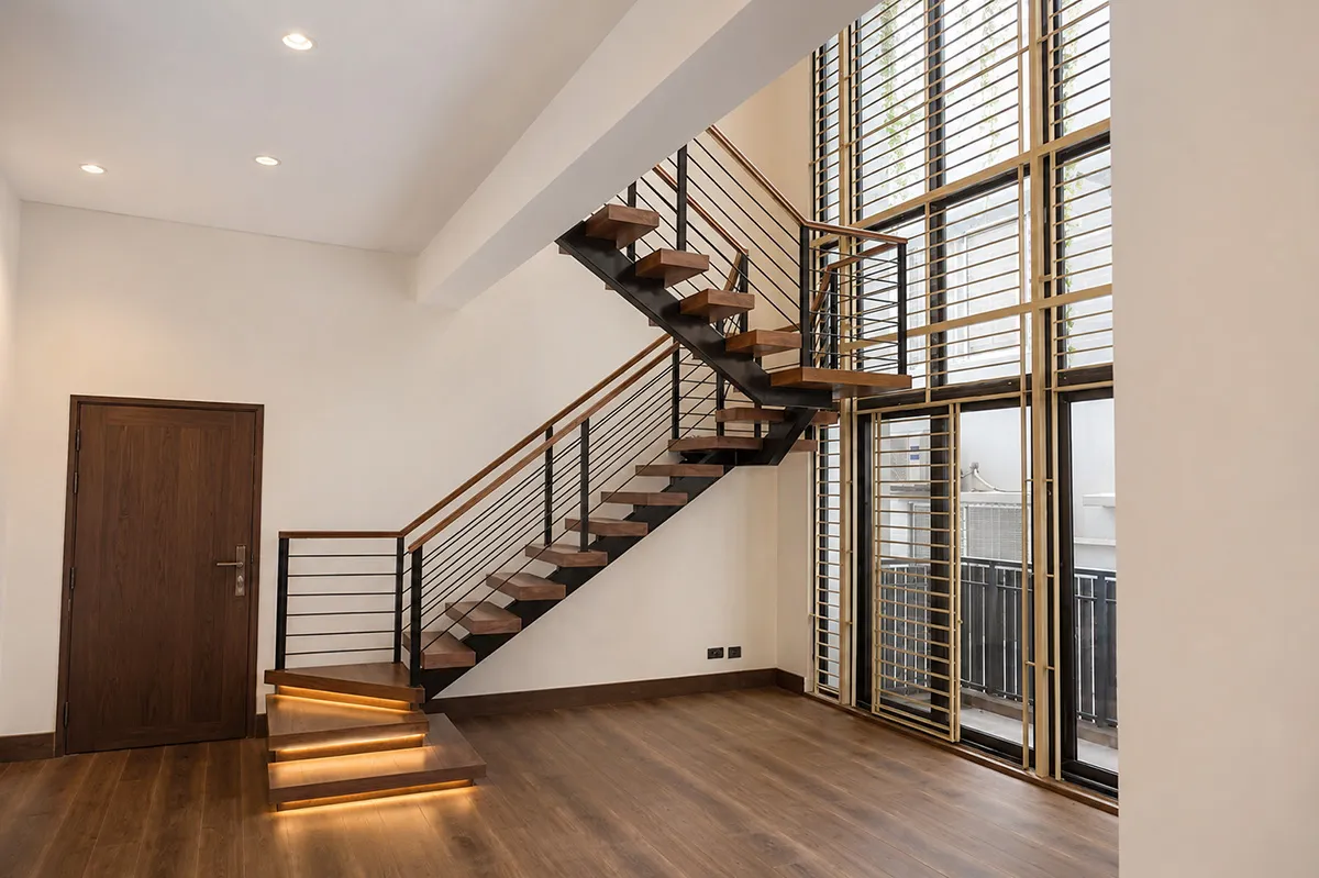 Floating timber stair treads and steel railing at the entry - duplex residence interior design, Bashundhara, Dhaka