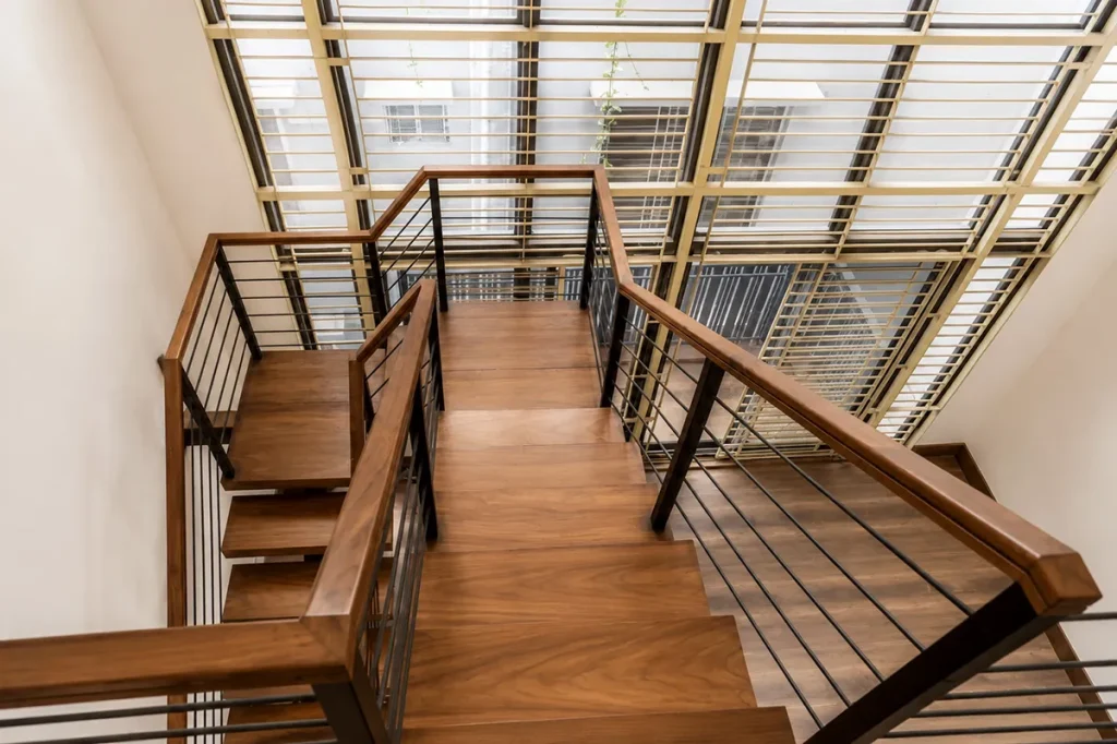 Upper landing and stair railing under a glazed roof - duplex residence interior design, Bashundhara, Dhaka