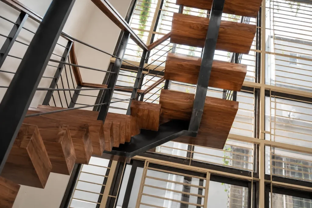 Timber tread and steel stringer detail seen from below - duplex residence interior design, Bashundhara, Dhaka